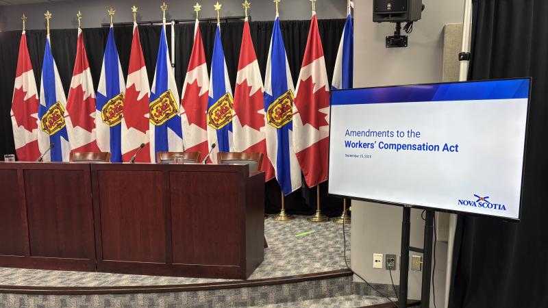 An image of government media room, showing flags of Canada and Nova Scotia.