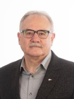 Portrait of Blair Richards, Worker Representative, Smiling in black blazer.